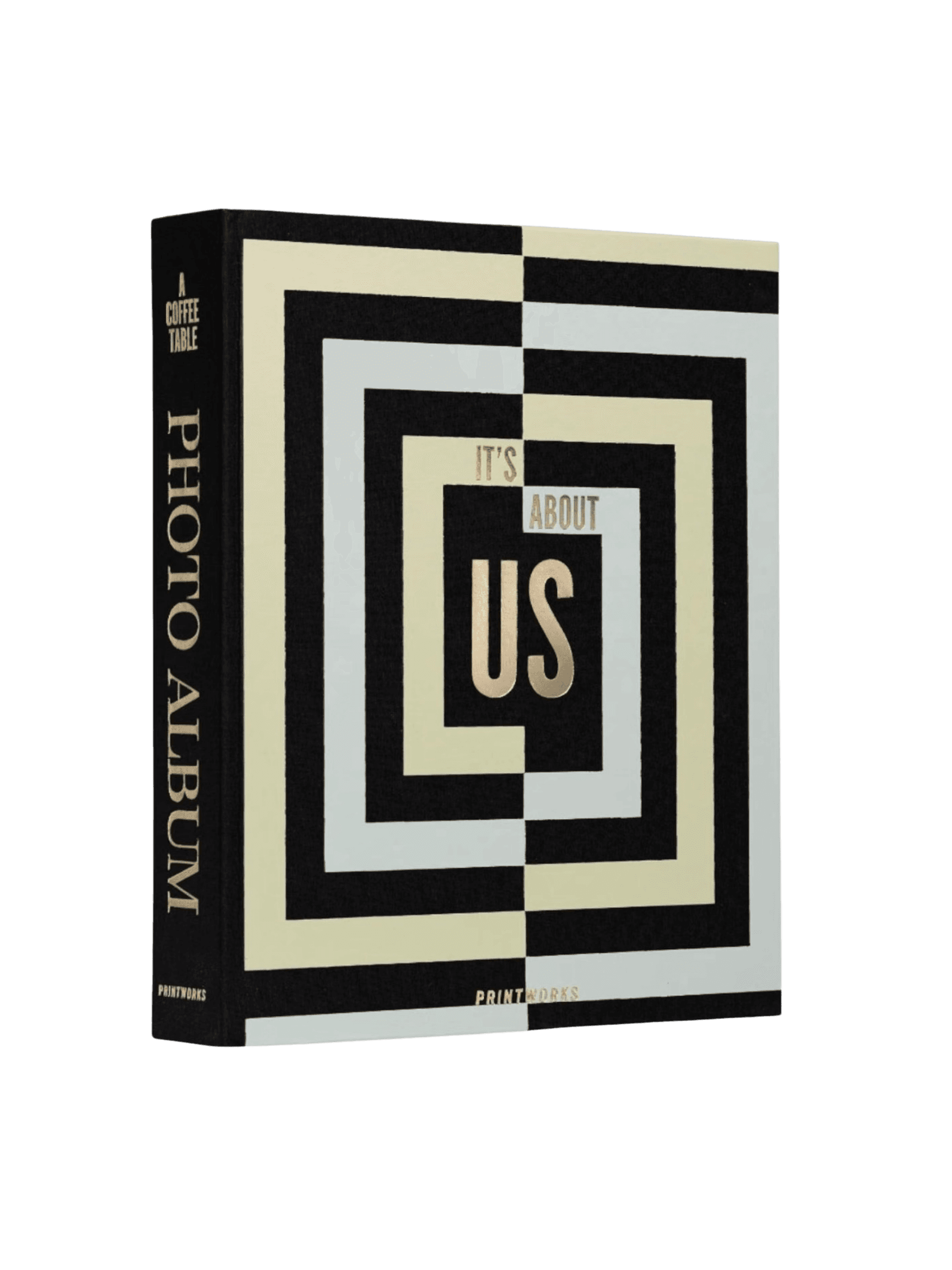 The Printworks "It's About Us" photo album, a black fabric-covered book with a concentric geometric cover design in black, cream, and pale blue